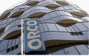 Modern building facade featuring wavy glass design and a prominent ORCO sign.