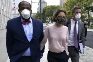 Clzre Bronfman, with her attorneys, walk into court for her sentencing hearing. She would not walk out