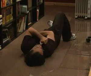 Keith Alan Raniere - poses for the camera while lying on the floor.