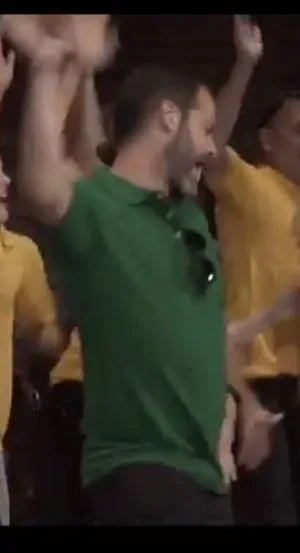 Emiliano dances on stage at an all-ESPian gathering during V-Week. His green shirt corresponds to his rank in ESP.