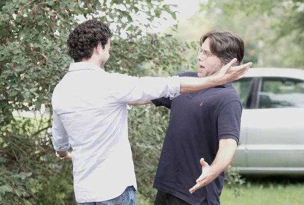 Emiliano Salinas embraces his then worshipful master Keith Raniere. Later, Salinas abandoned the hero, leaving him to his sad fate all alone.