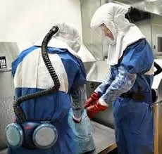 Health care professionals wear respirators with hoods. It also comes with a helmet. Pictured is a 3M Jupiter Respirator.