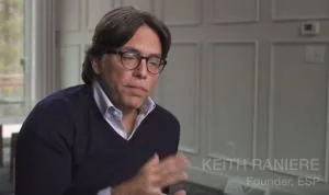 Keith Raniere said at V-Week 2016: "I am very devilish. I think I am probably the worst coach in the world because I am just a demon. You know if I am coaching you I am going to have you do something with your left hand, you're right hand, your left foot, you're right foot, your head, and then I am going to ask you to do the hard thing. 

I do this and it is with a twisted sense of pleasure in someways. The extra effort being able to pull effort out of others and Pull effort out of myself. So here we are coming into V week. And the people involved in simply human and other things there. I can't tell you how much they took on this year. The artistic and musical piece that you saw  was original. Completely.