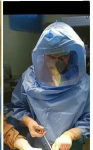 Surgeon wearing a mask underneath a shield. Stryker shield is a good brand of shields