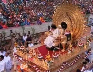 Sai Baba on his throne before thousands of adoring devotees.