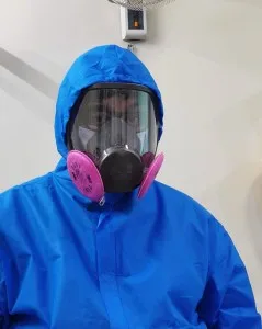 Dentist wearing a mask underneath a mask respirator.What about the rest of us?