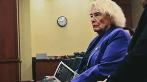 Representative Zoe Lofgren holds a brochure entitled "American's Family"