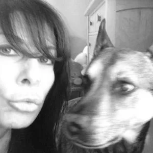 Toni with her dog, Raymona, who fortuitously peed on the carpet and saved Scott Foley's balls.