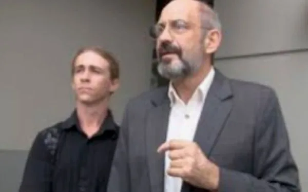 Sulla stands with his ‘strawman’, Jason Hester, at the non-judicial foreclosure auction of the stolen property.