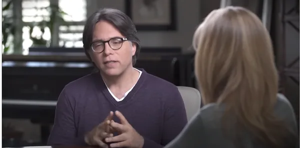 Keith Raniere speaks with his DOS slave Allison Mack