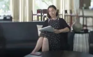Nxivm-American-Greed-Screenshot-Angela-Ucci-Seated-Reading.jpg