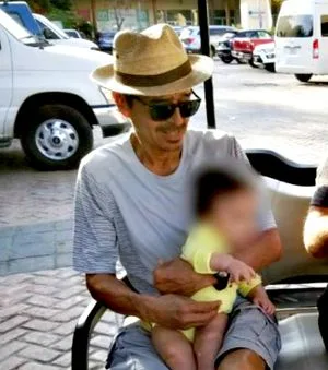 Camila's father Hector, with his grandson.