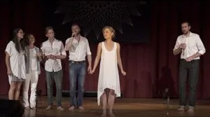 Allison Mack, wearing the same white dress, sings on her Vanguard's birthday, August 26, 2016. Her Vanguard is in the audience.